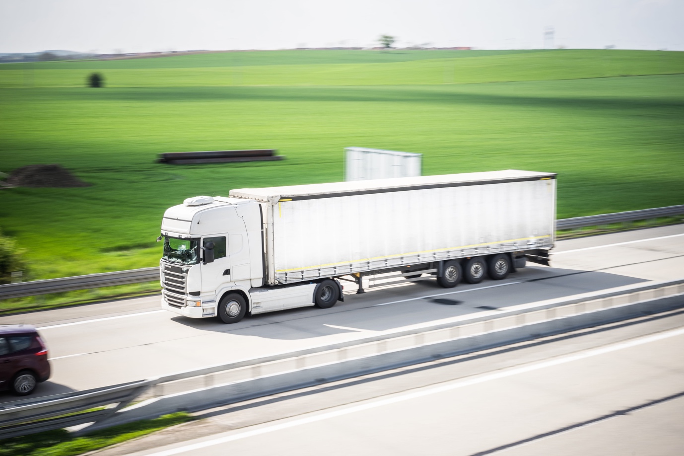 A truck that is driving down the road Description automatically generated